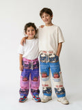 Smiling toddler and a tween in a white tee's and chunky sneakers wearing kids’ Purity Bokomo flour bag pants